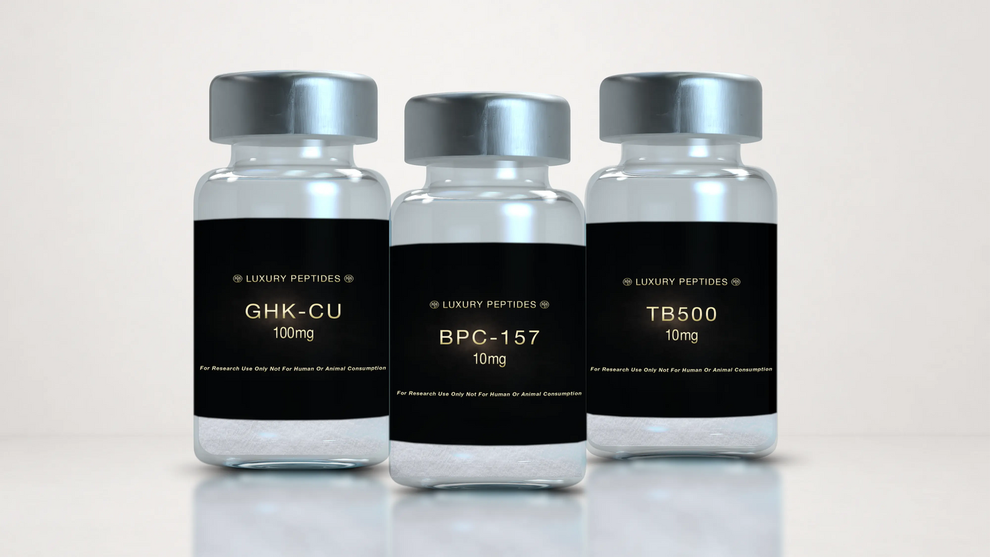 Three Luxury Peptides research vials labeled BPC-157 10mg, TB-500 10mg, and GHK-Cu 100mg displayed on a neutral background with a soft reflective surface.