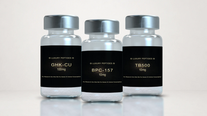 Three Luxury Peptides research vials labeled BPC-157 10mg, TB-500 10mg, and GHK-Cu 100mg displayed on a neutral background with a soft reflective surface.