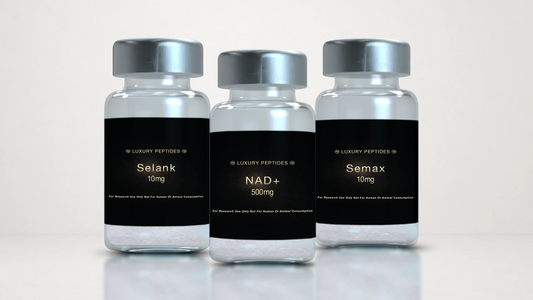 Three Luxury Peptides research vials labeled NAD+ 500mg, Selank 10mg, and Semax 10mg displayed on a neutral background with a soft reflective surface.