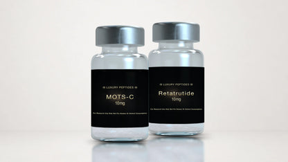 Two Luxury Peptides research vials labeled MOTS-C 10mg and Retatrutide 10mg displayed side by side on a neutral background with a soft reflective surface.