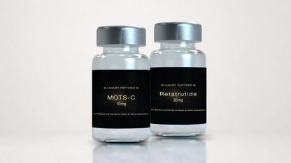 Two Luxury Peptides research vials labeled MOTS-C 10mg and Retatrutide 30mg displayed side by side on a neutral background with a soft reflective surface.