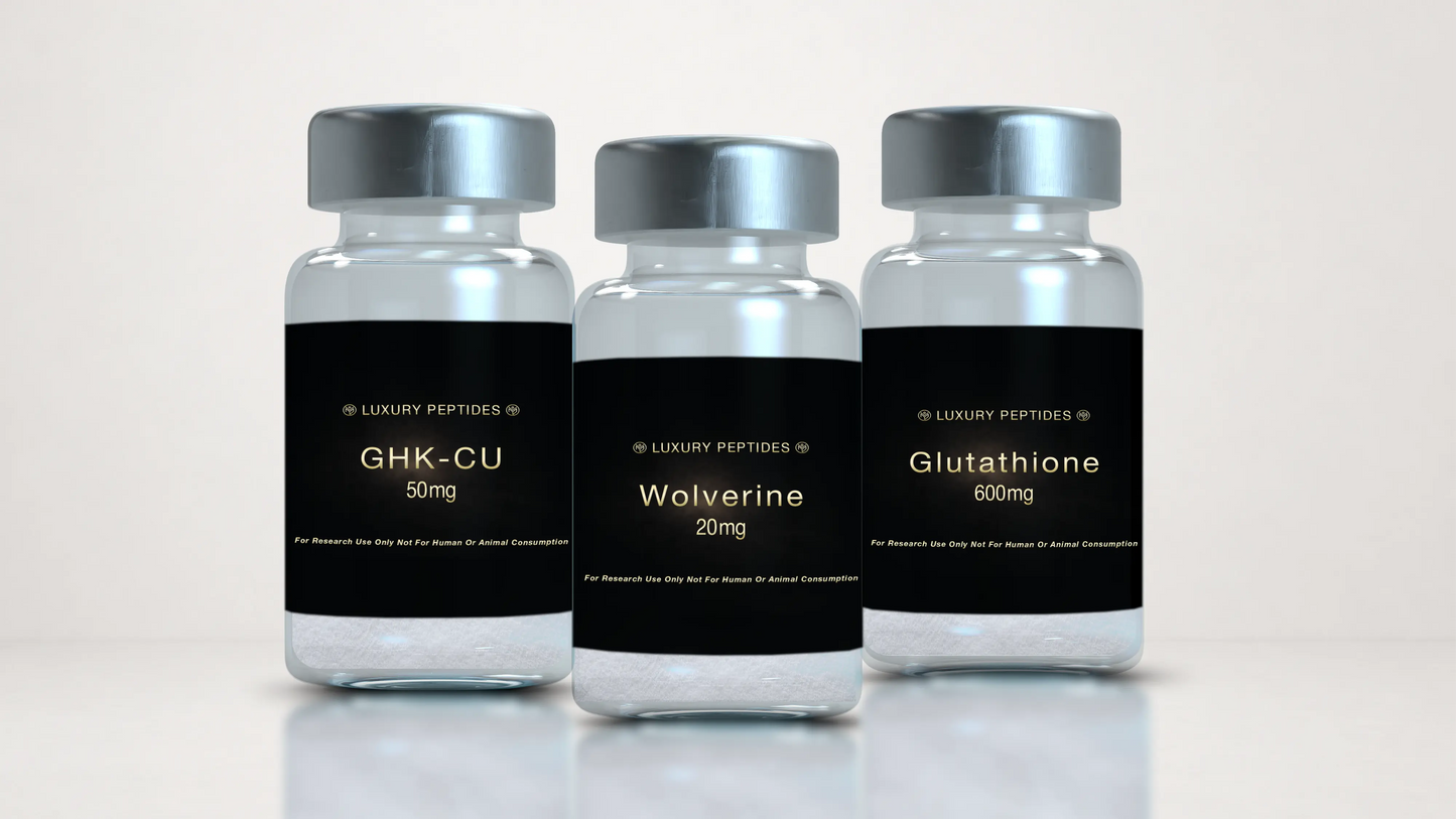 Three Luxury Peptides research vials labeled Wolverine 20mg, GHK-Cu 50mg, and Glutathione 600mg displayed on a neutral background with a soft reflective surface.